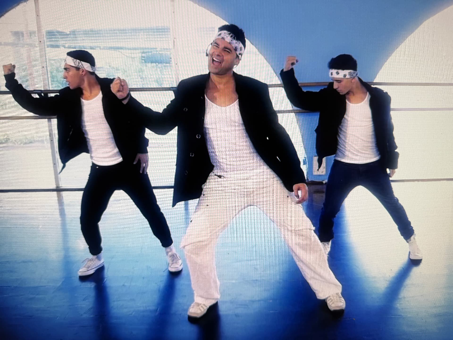 Dr. Reef Karim dancing with a crew on set