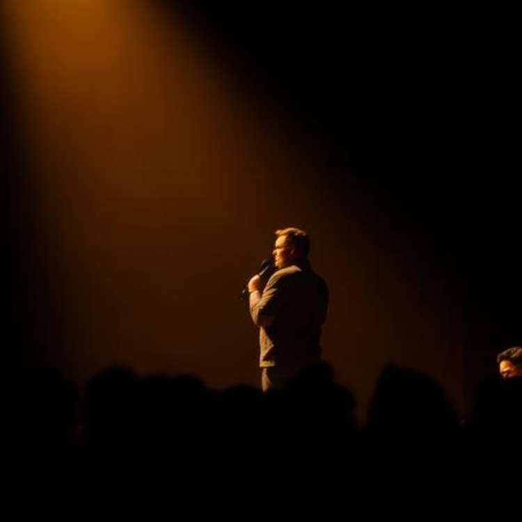 Storyteller under a single spotlight on stage
